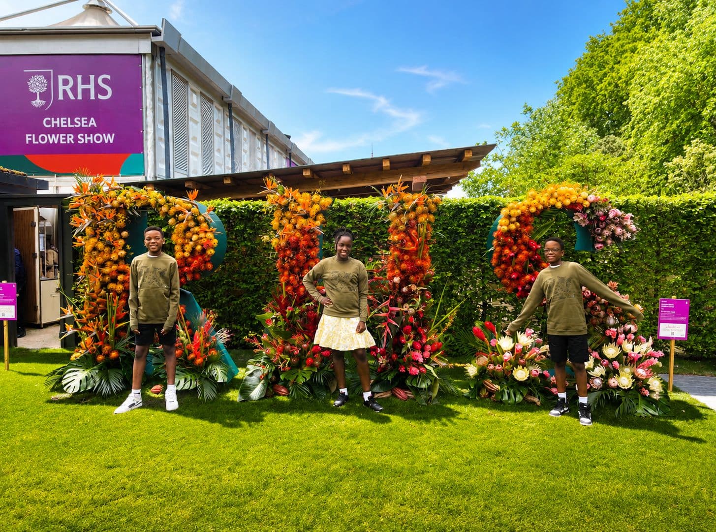 Planet Trio at the RHS Chelsea Flower Show with floral RHS letters
